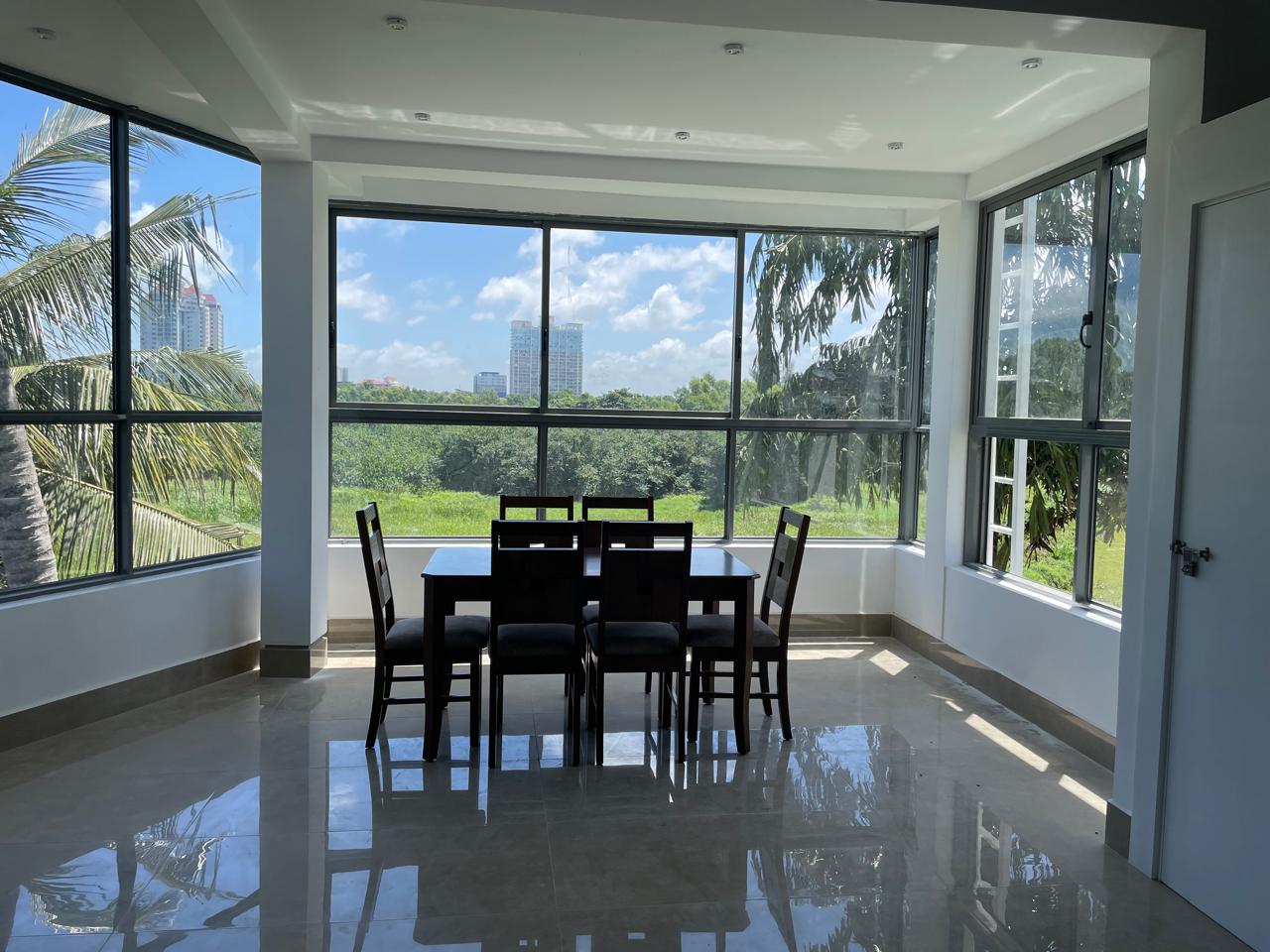 Spacious open-plan living area with marble flooring and natural light