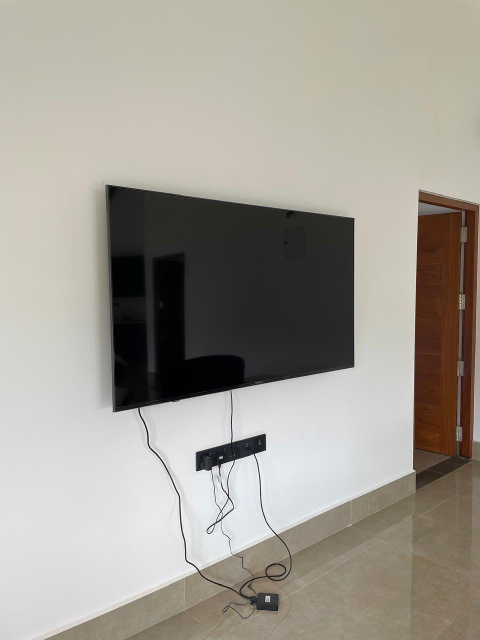 Wall-mounted flat-screen smart TV in the lounge