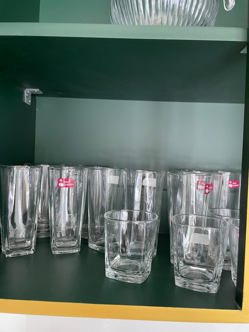 Tall highball glasses and short tumblers in the cupboard