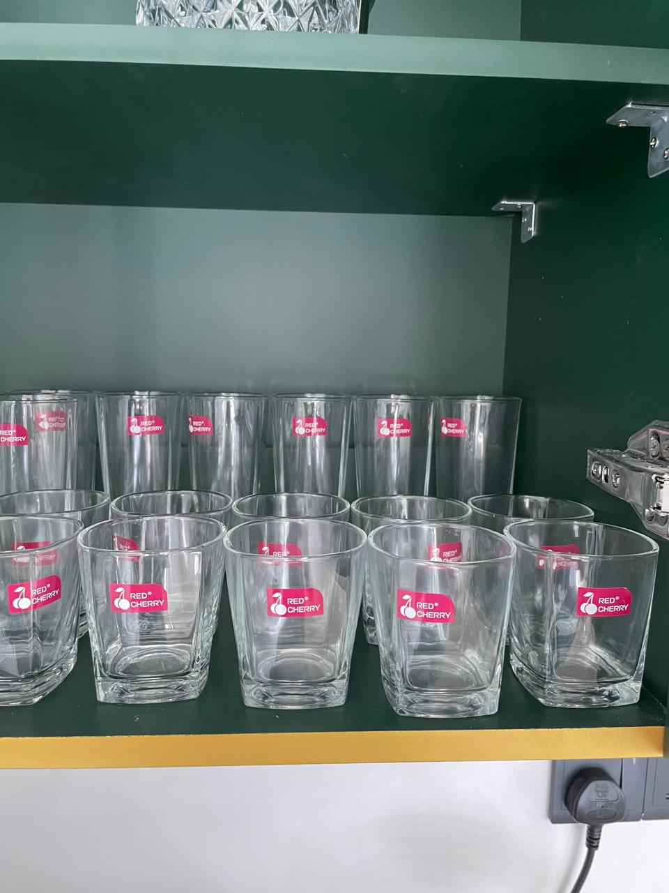 Tall highball glasses and short tumblers in the cupboard